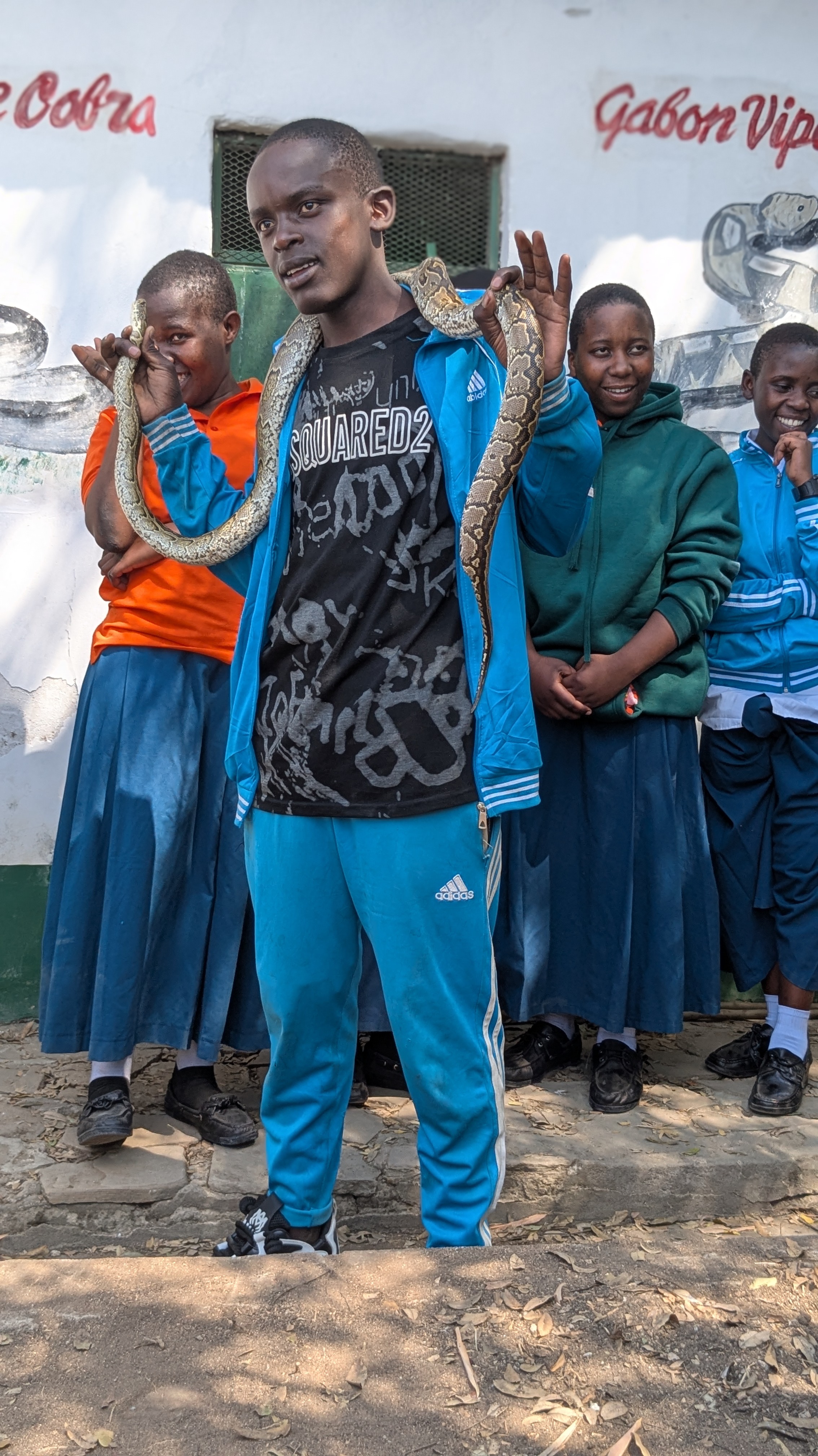 Students showing courage with snake